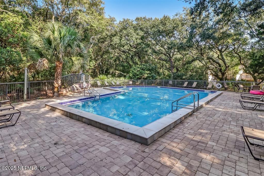 2122 Beachwood Road, Unit 2122 Fernandina Beach, FL 32034 - Photo 25 of 41 a view of a backyard with lawn chairs and wooden fence