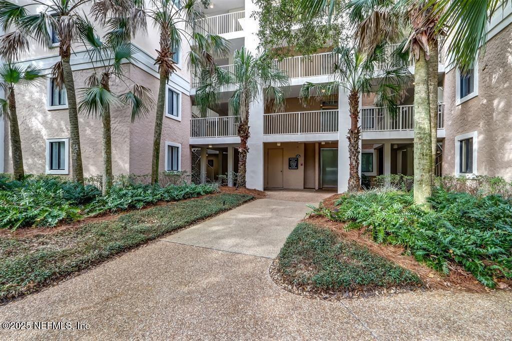 2122 Beachwood Road, Unit 2122 Fernandina Beach, FL 32034 - Photo 26 of 41 a front view of a multi story building with a yard