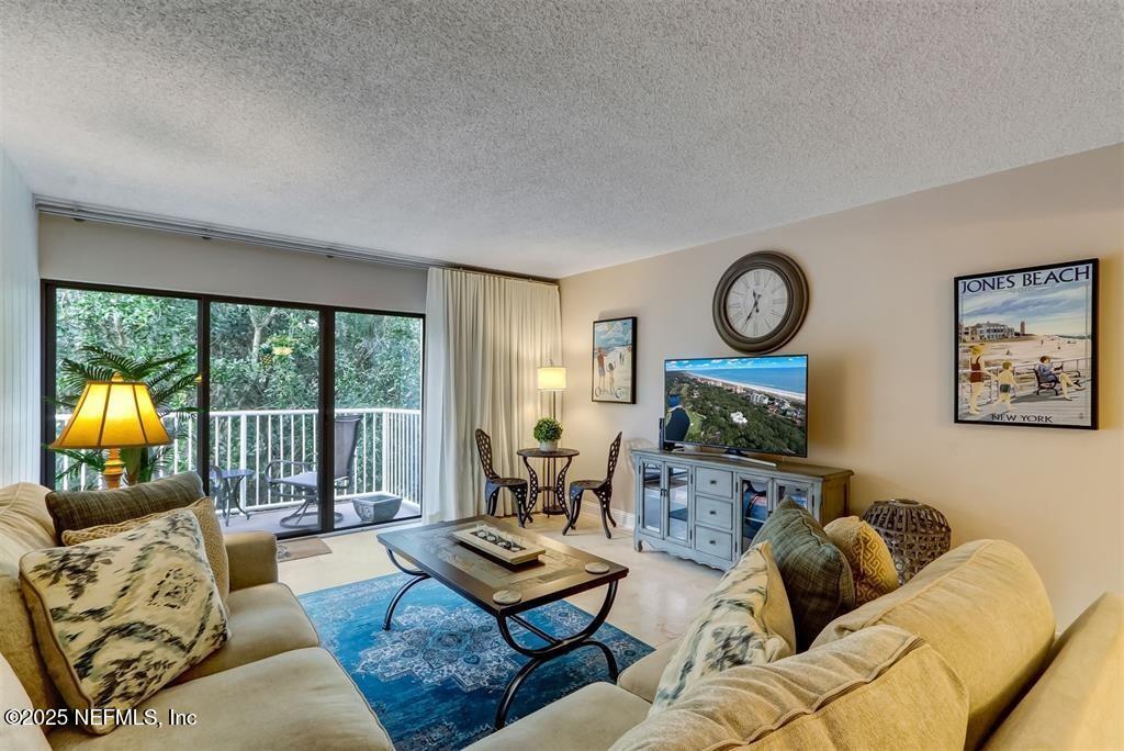 2122 Beachwood Road, Unit 2122 Fernandina Beach, FL 32034 - Photo 3 of 41 a living room with fireplace furniture and a large window