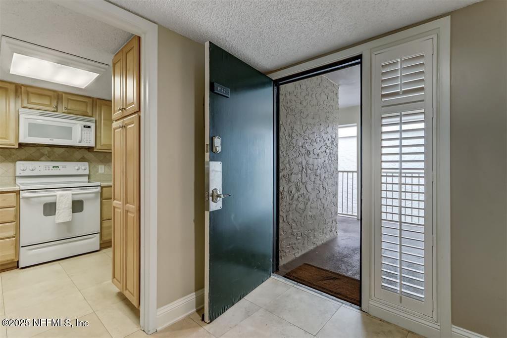 2122 Beachwood Road, Unit 2122 Fernandina Beach, FL 32034 - Photo 5 of 41 a view of a kitchen with an entryway and a hallway