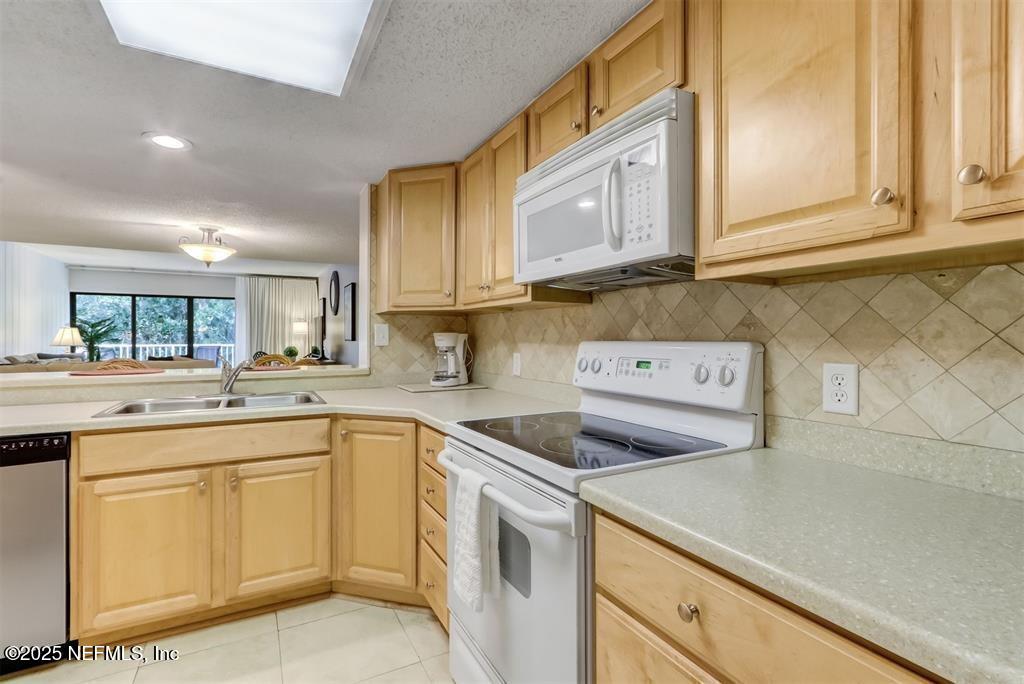 2122 Beachwood Road, Unit 2122 Fernandina Beach, FL 32034 - Photo 7 of 41 a kitchen with cabinets appliances a sink and a counter top space