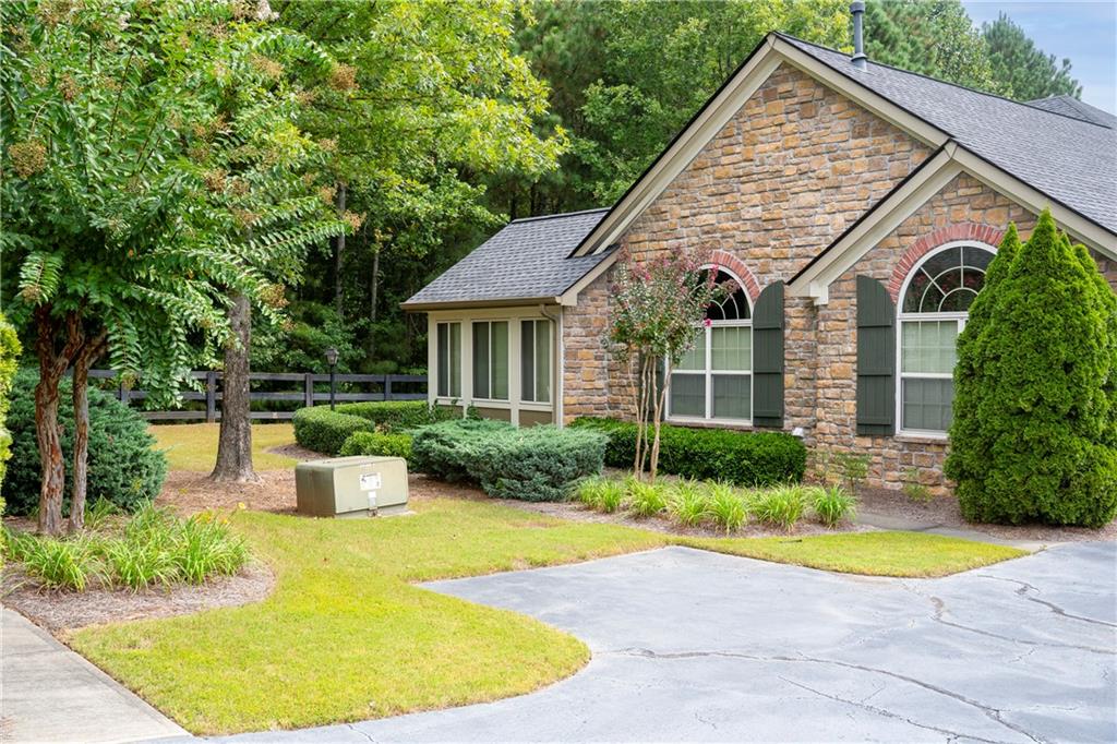 5208 Stone Village Circle Northwest Kennesaw, GA 30152 - Photo 1 of 1 a view of a house with swimming pool and a yard