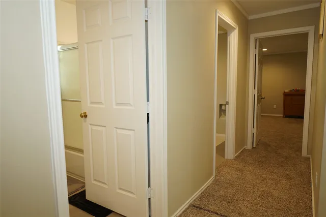 a view of a bathroom from a hallway