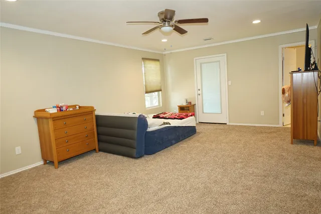 a living room with furniture and a ceiling fan