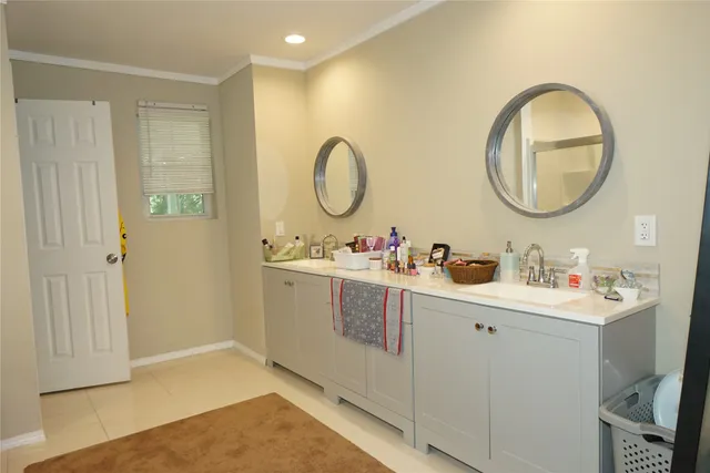 a bathroom with a double vanity sink and a mirror
