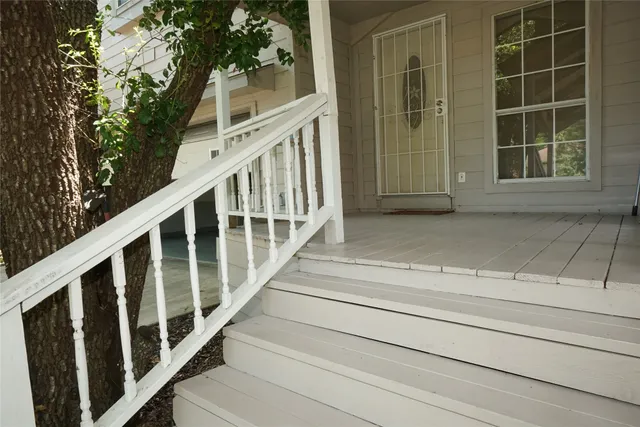 a view of staircase with white walls and windows