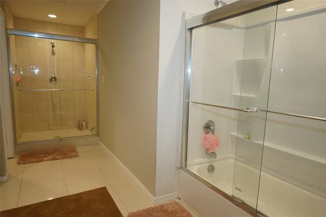 a bathroom with a bathtub and a shower