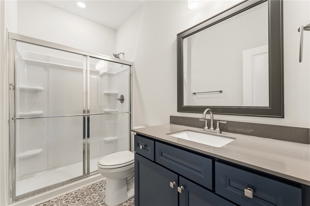 1108 Manse Jolly Road Anderson, SC 29621 - Photo 16 of 45 This modern bathroom features a stylish vanity and a sleek shower with glass enclosure.