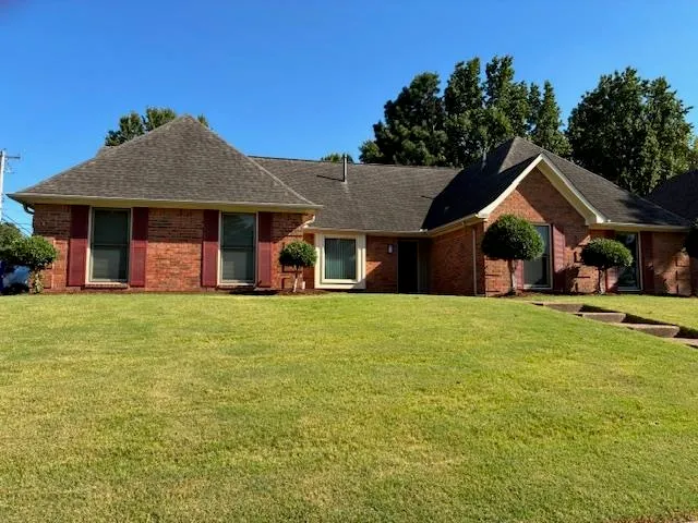 a front view of a house with a garden and porch