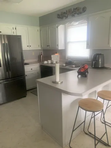 a kitchen with a sink cabinets and window