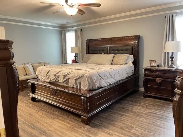 a bed sitting in a bedroom next to a window with a dresser