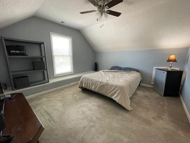 a bedroom with a bed and window