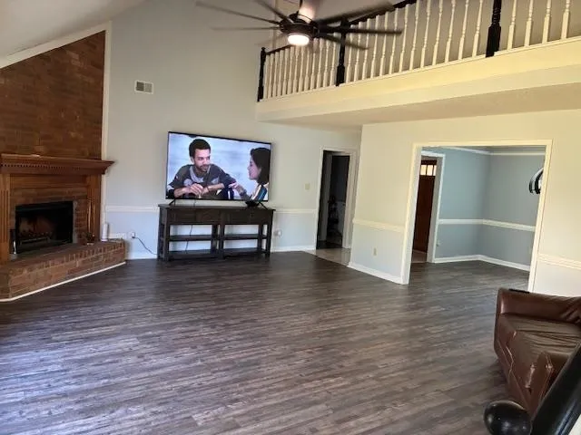 a view of a hallway with wooden floor and a fireplace