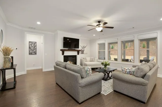 a living room with furniture a fireplace and a flat screen tv