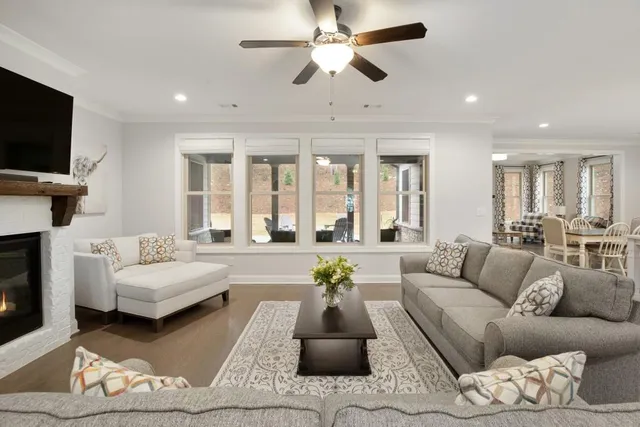 a kitchen with a sink a stove a refrigerator and white cabinets