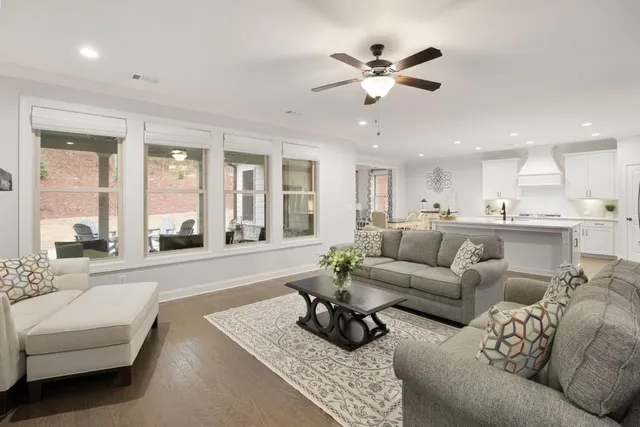 a kitchen with stainless steel appliances granite countertop a stove refrigerator and a sink