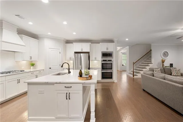 a spacious bedroom with a large bed and a couch