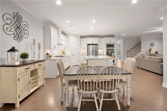a spacious bedroom with a large bed a chandelier and a couch