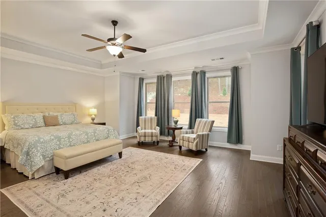 a bathroom with a granite countertop sink a toilet and a shower