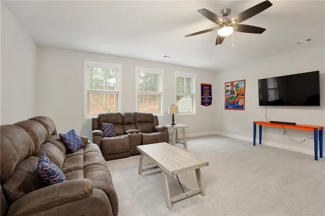 an aerial view of residential houses with outdoor space and trees