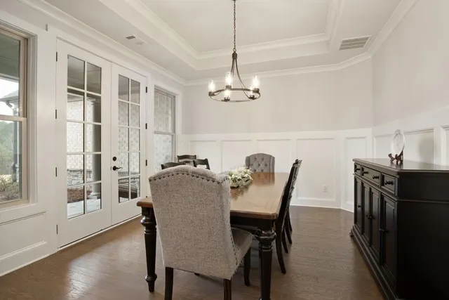 a living room with furniture a ceiling fan and a flat screen tv