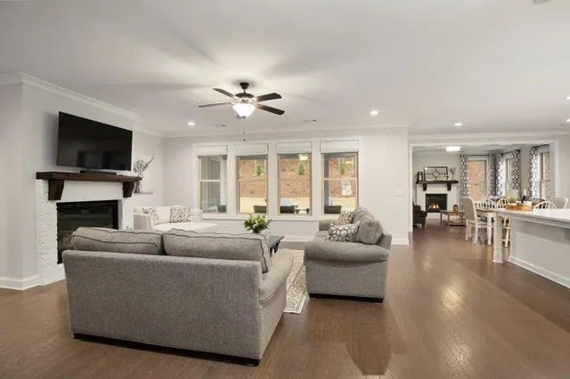 a living room with furniture a flat screen tv and a fireplace