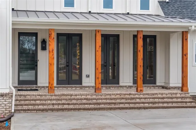 a view of a big room with wooden floor fire place and windows