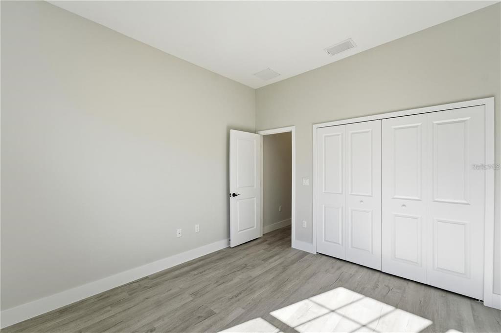 13205 Southwest 65th Circle Ocala, FL 34473 - Photo 20 of 32 a view of an empty room with wooden floor