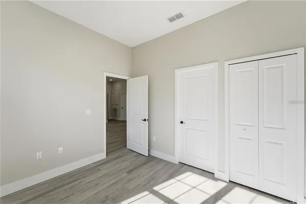 a view of an empty room and wooden floor
