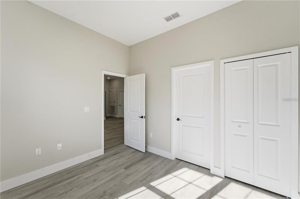 13205 Southwest 65th Circle Ocala, FL 34473 - Photo 21 of 32 a view of an empty room and wooden floor