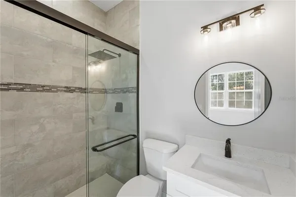 a bathroom with a sink toilet and a mirror
