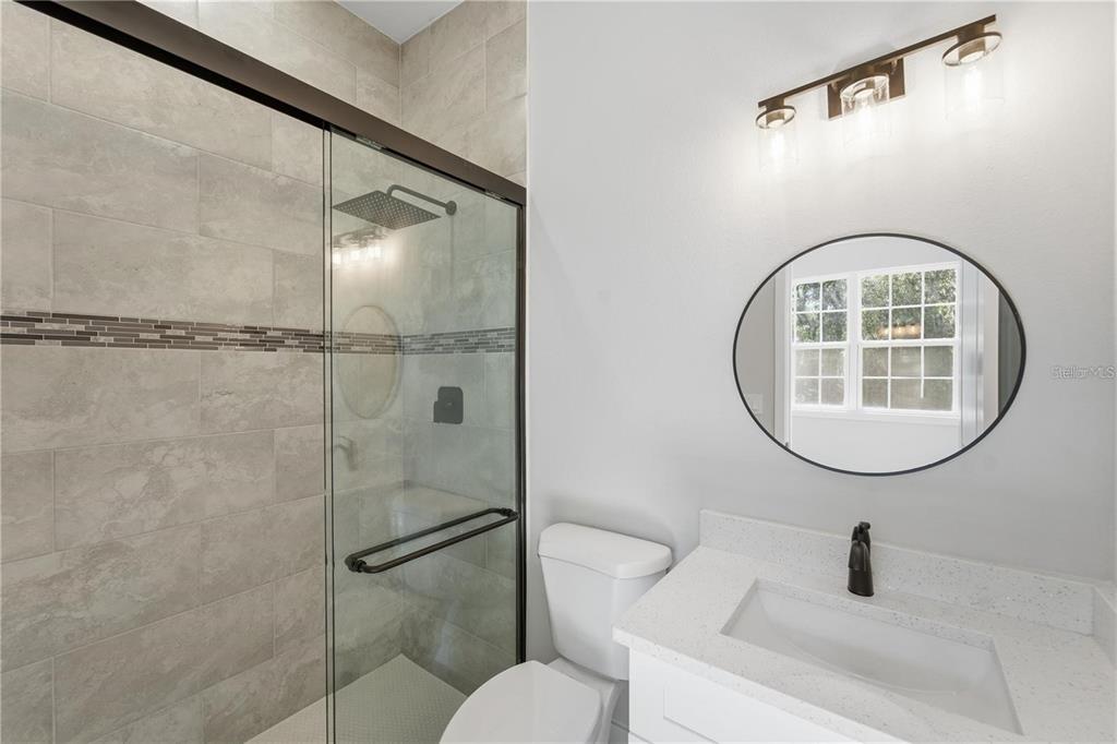 13205 Southwest 65th Circle Ocala, FL 34473 - Photo 22 of 32 a bathroom with a sink toilet and a mirror