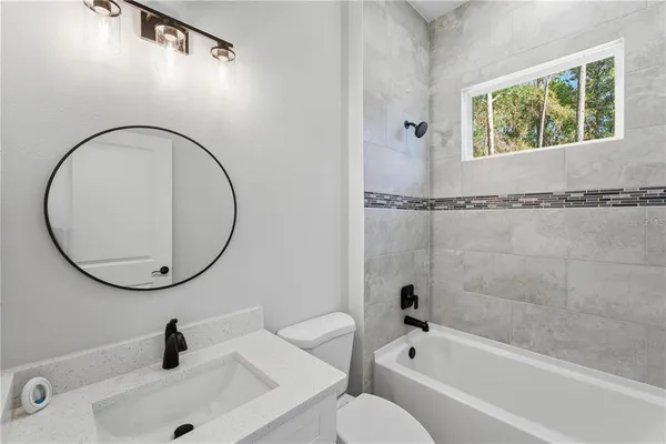 a bathroom with a sink a toilet and a tub