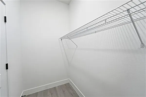 a view of small space with racks on wall and a window