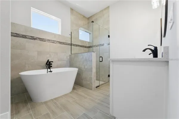 a bathroom with a bathtub and shower
