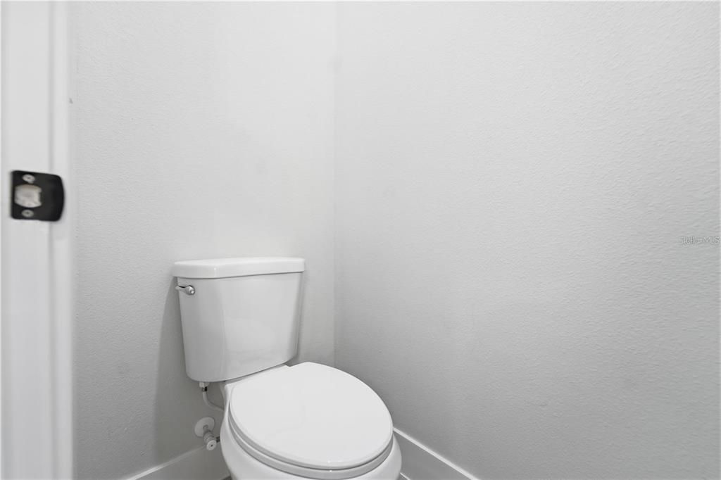 13205 Southwest 65th Circle Ocala, FL 34473 - Photo 28 of 32 a white toilet sitting next to a white wall