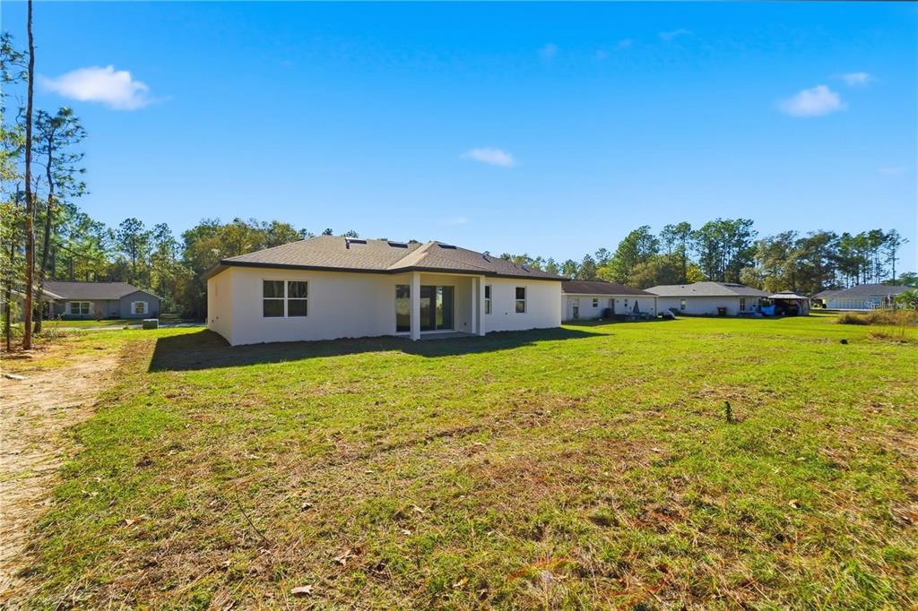 13205 Southwest 65th Circle Ocala, FL 34473 - Photo 32 of 32 a view of a house with a big yard