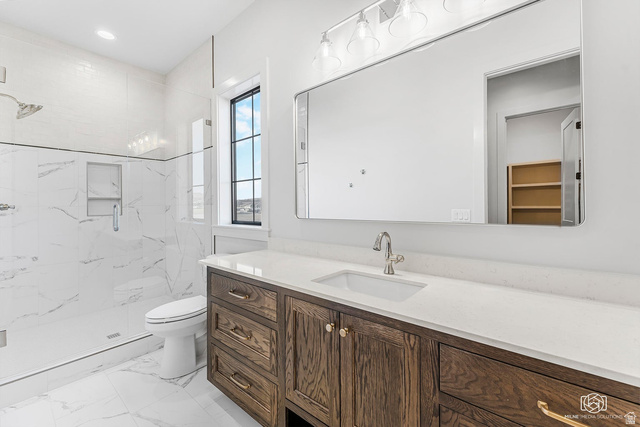 1468 South Red Cliffs Temple Lane St. George, UT 84790 - Photo 39 of 64 Bathroom with vanity, a marble finish shower, light marble finish floors, recessed lighting, and a spacious closet