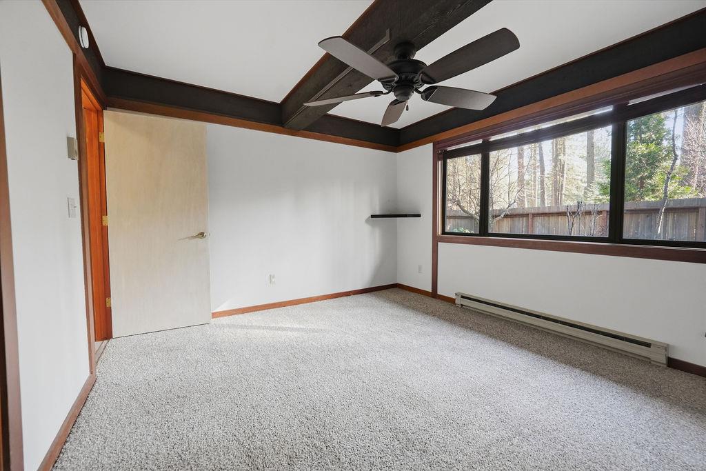 39 Graeagle Meadows Road Graeagle, CA 96103 - Photo 27 of 51 an empty room with a ceiling fan and windows