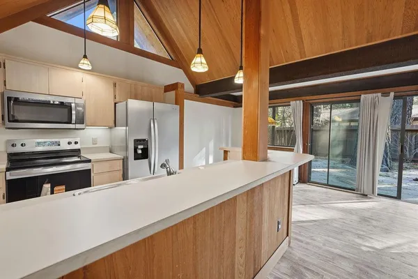 a kitchen with stainless steel appliances a stove a refrigerator and a sink