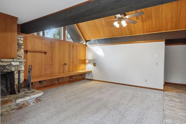 a view of a room with wooden floor
