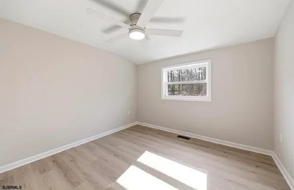 a view of a house with a yard covered in snow