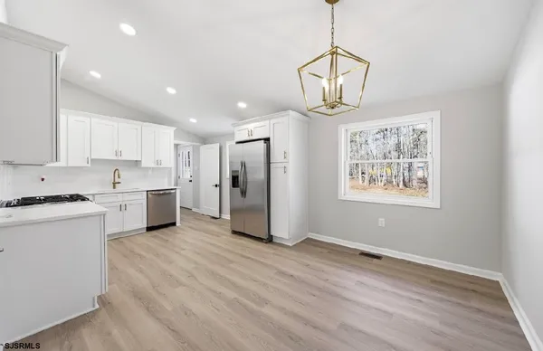 a kitchen with stainless steel appliances granite countertop a stove and a refrigerator