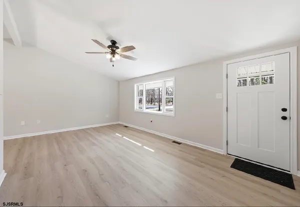 wooden floor in an empty room with a window