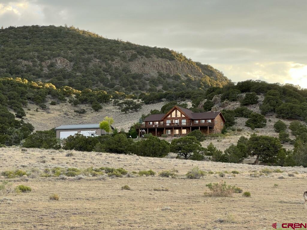 41400 Co Road Saguache, CO 81149 - Photo 1 of 45 a view of a yard with a large tree