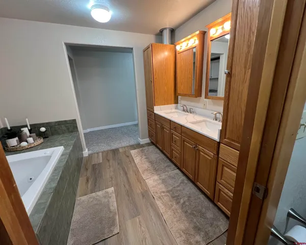 a bathroom with a sink a mirror and a bathtub