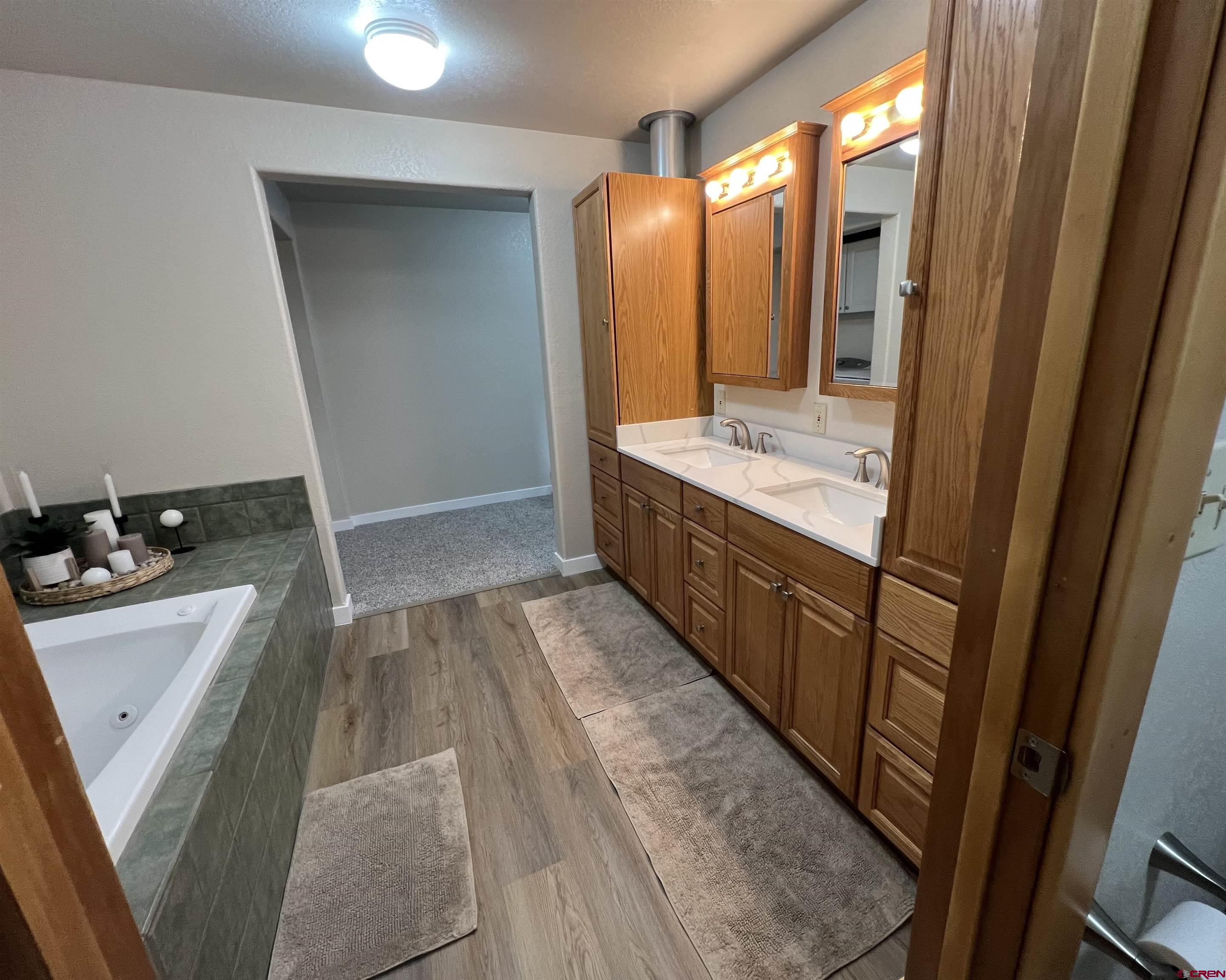 41400 Co Road Saguache, CO 81149 - Photo 11 of 45 a bathroom with a sink a mirror and a bathtub