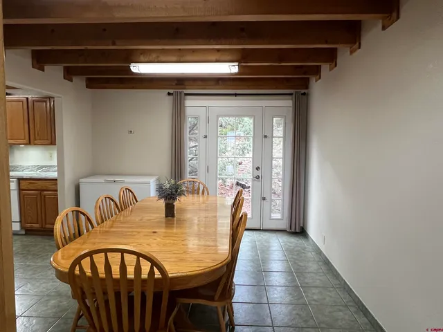 a dining room with furniture and window