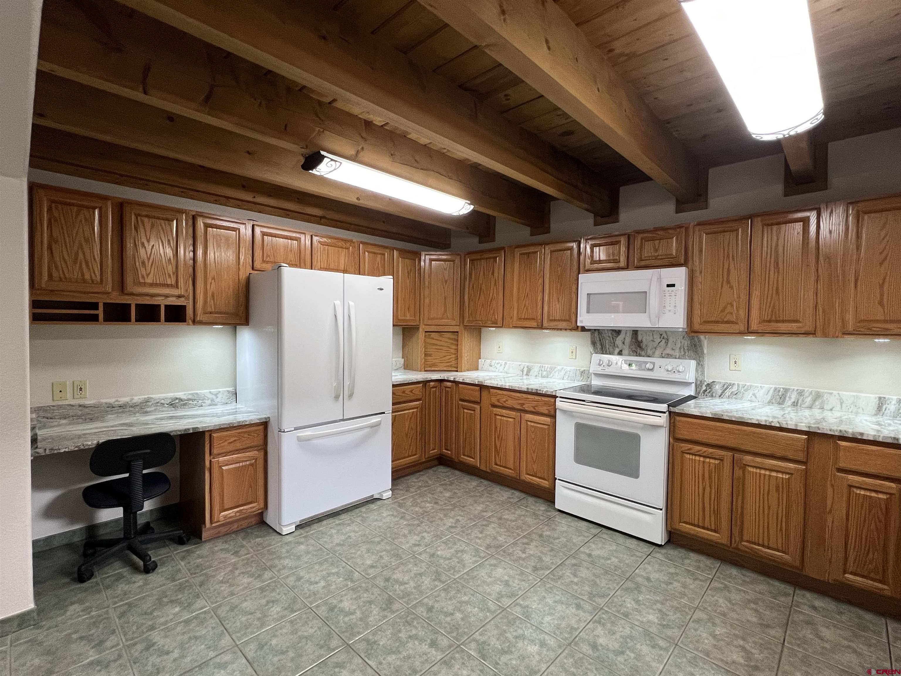 41400 Co Road Saguache, CO 81149 - Photo 16 of 45 a kitchen with stainless steel appliances granite countertop a sink stove and refrigerator
