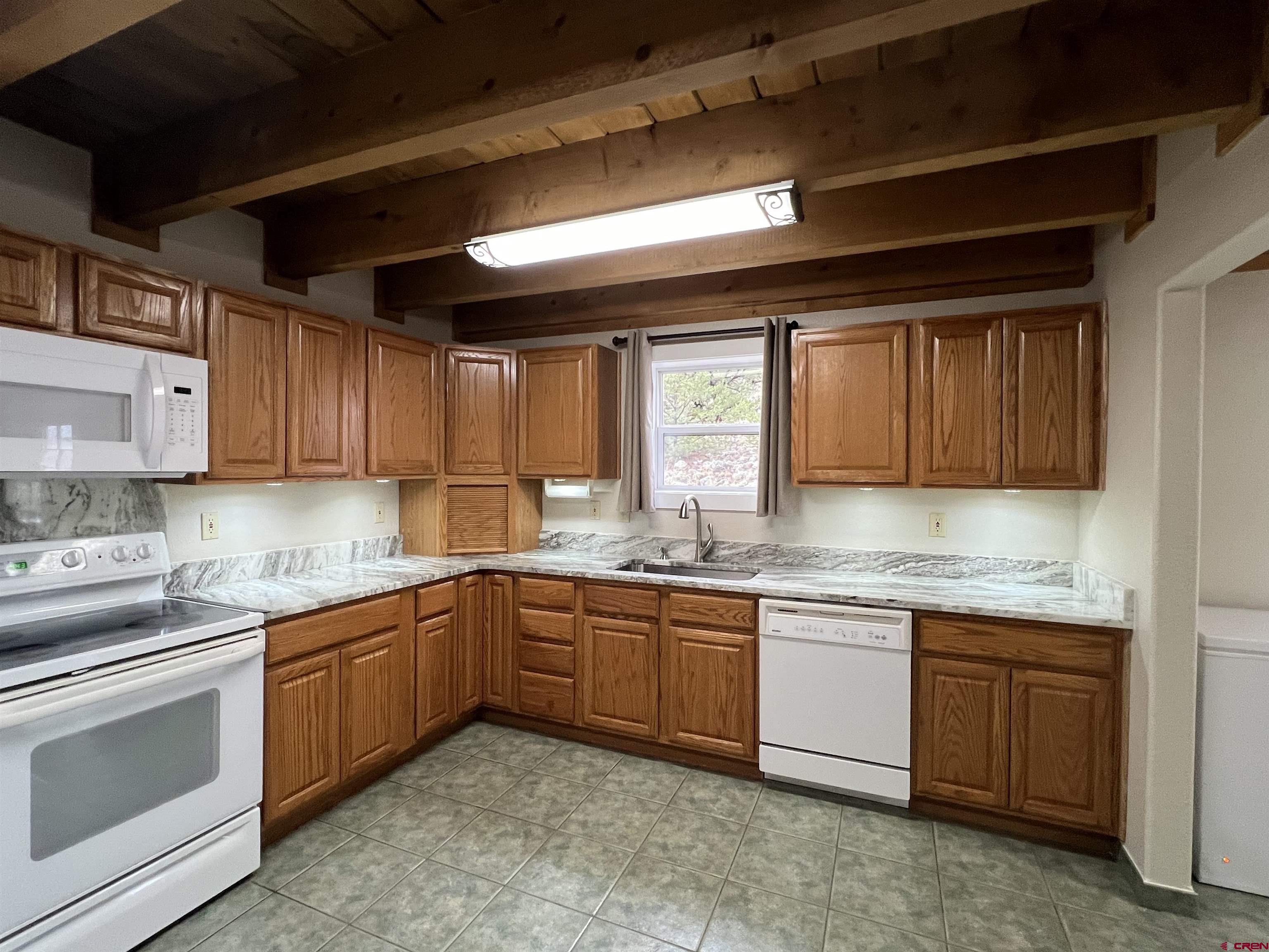 41400 Co Road Saguache, CO 81149 - Photo 16 of 45 a kitchen with a sink stove and cabinets